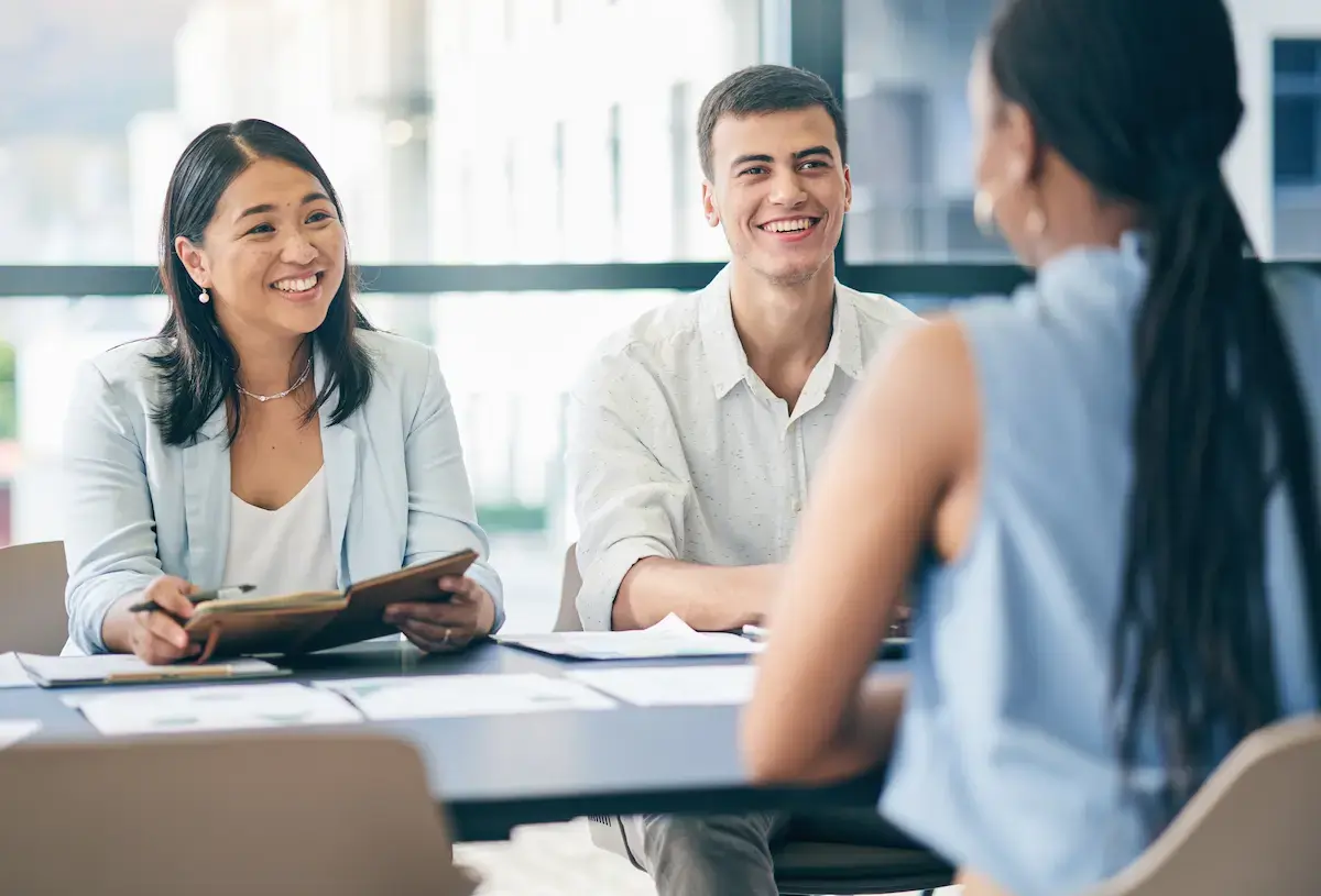 Two hospital executives interview a nurse for a RN position