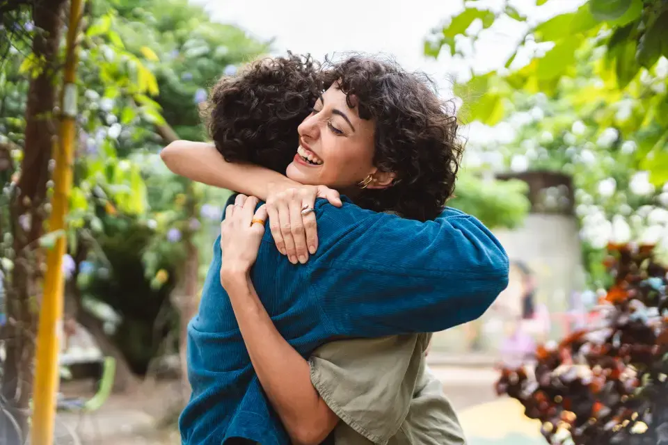 A travel nurse and a loved one hugging each other before leaving on assignment