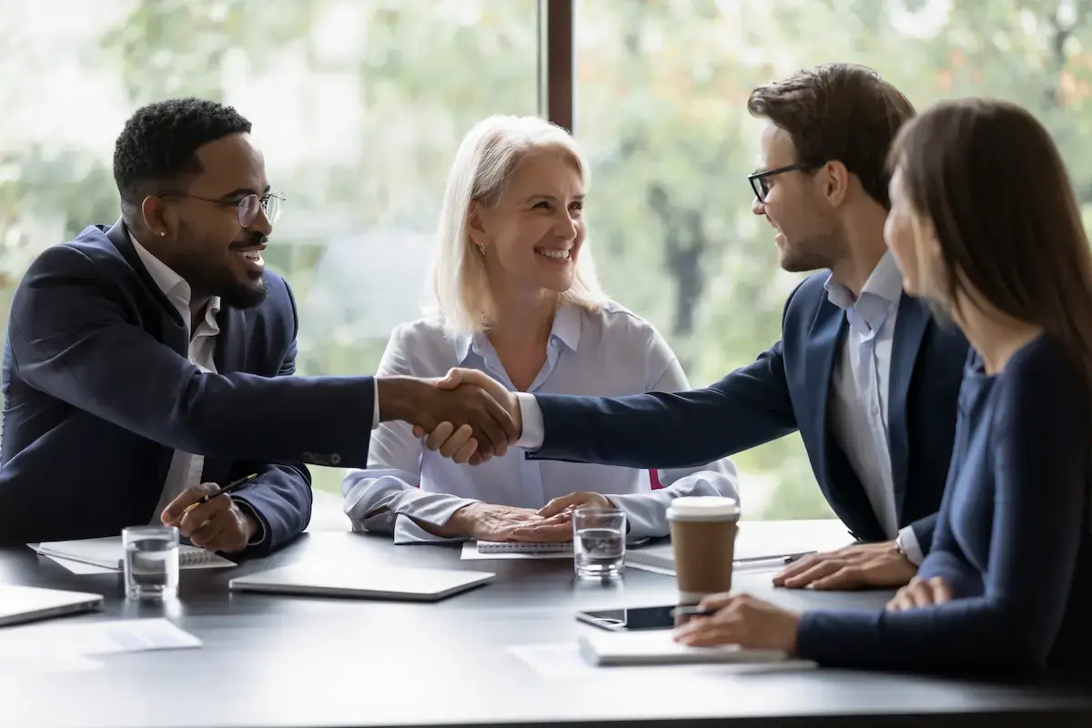 Group of healthcare businesspeople shaking hands in a meeting room