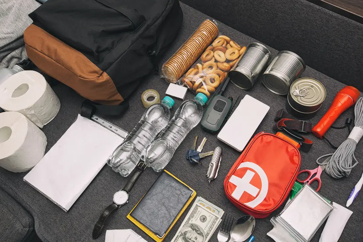 Emergency and disaster essentials kit spread across a table